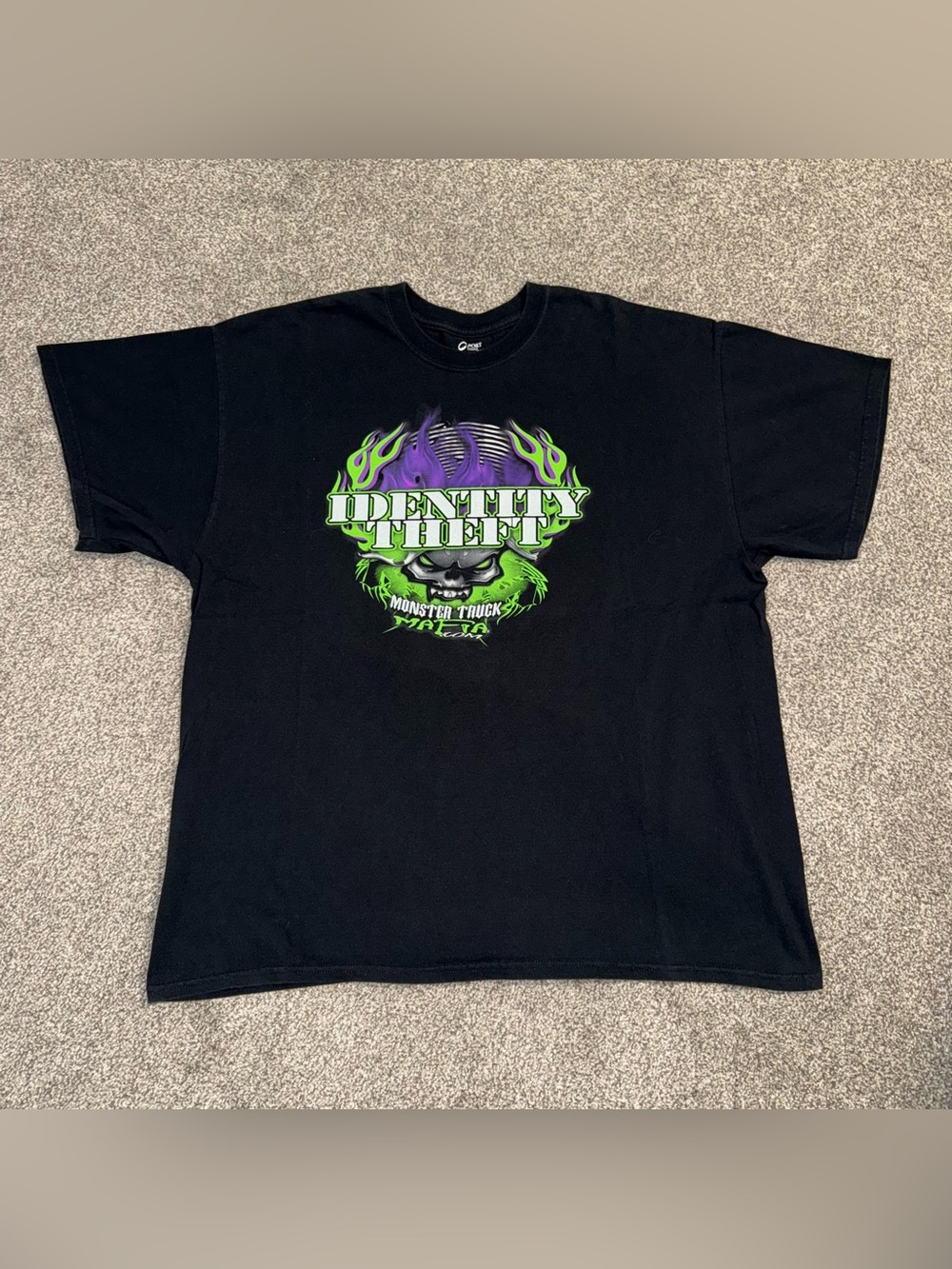 Identity Theft Monster Truck Black T-Shirt with Green and Purple Graphic